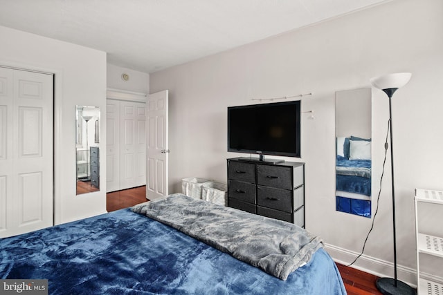 bedroom with dark wood-type flooring and heating unit