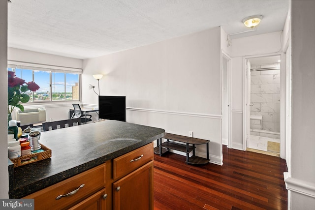 kitchen featuring dark hardwood / wood-style floors, cooling unit, and a textured ceiling