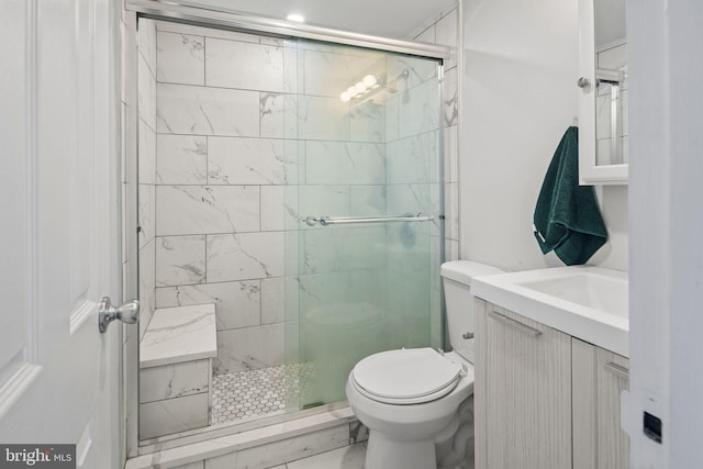 bathroom featuring vanity, toilet, and walk in shower