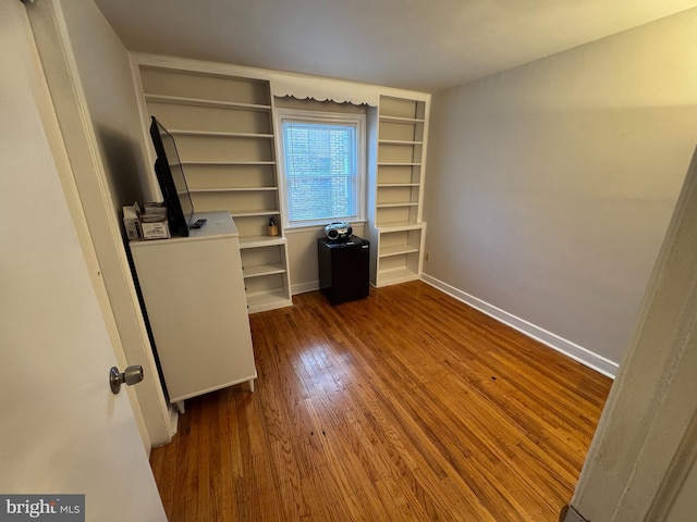 unfurnished bedroom with dark hardwood / wood-style flooring