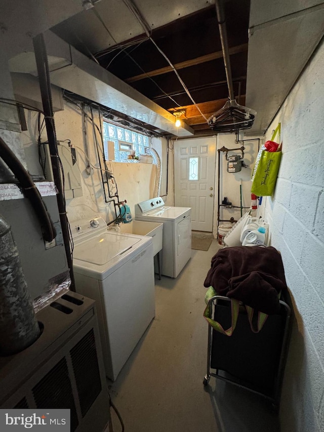 clothes washing area featuring sink and washing machine and clothes dryer