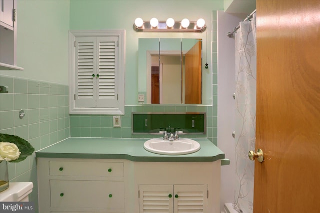 bathroom with tile walls, backsplash, toilet, and vanity