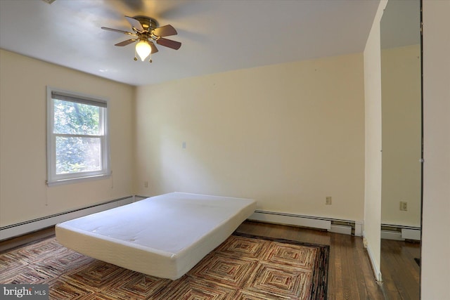 bedroom with hardwood / wood-style flooring, baseboard heating, and ceiling fan