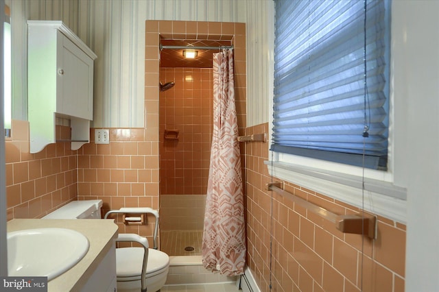 bathroom with tile walls, toilet, curtained shower, and vanity