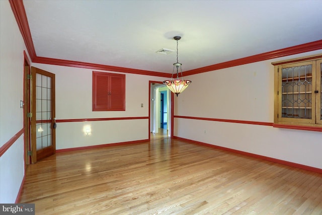 unfurnished room with crown molding and light wood-type flooring