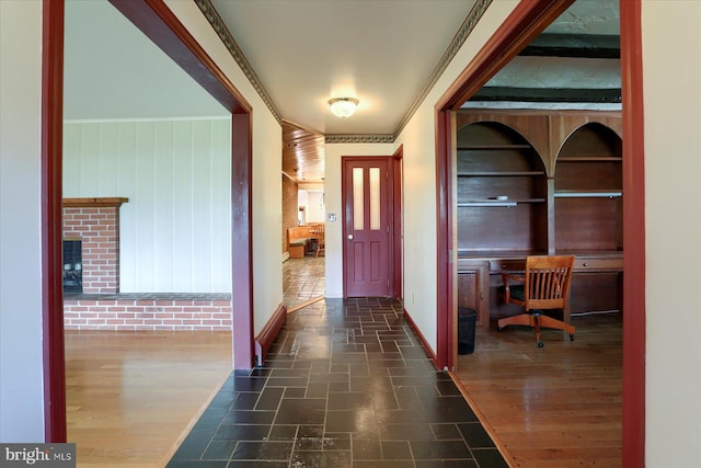 corridor featuring ornamental molding and wood-type flooring