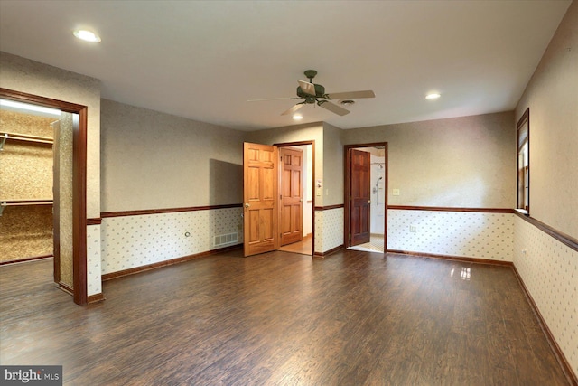 spare room with dark wood-type flooring and ceiling fan