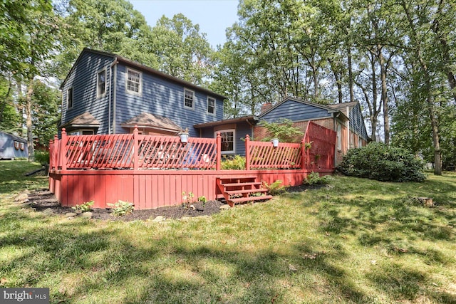 back of property with a deck and a yard