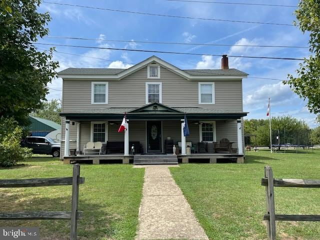 view of front of property with covered porch and a front yard