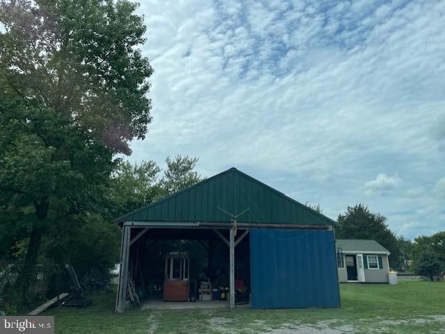 view of outbuilding featuring a lawn