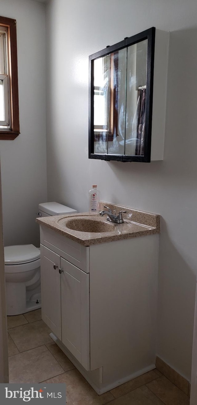 bathroom featuring vanity, toilet, and tile patterned floors