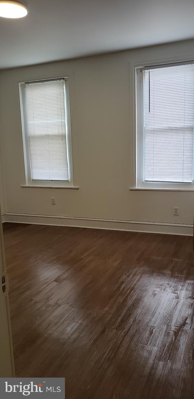 empty room featuring dark wood-type flooring