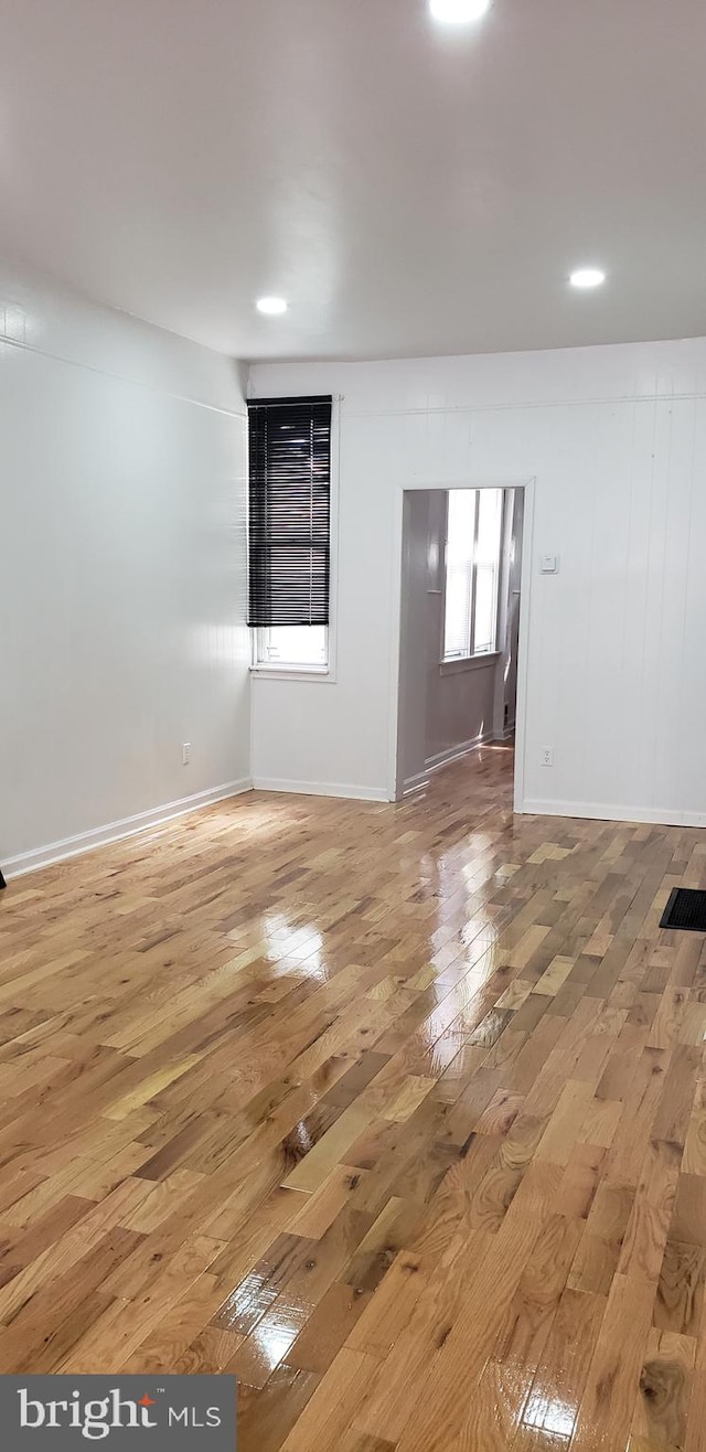 empty room with hardwood / wood-style flooring