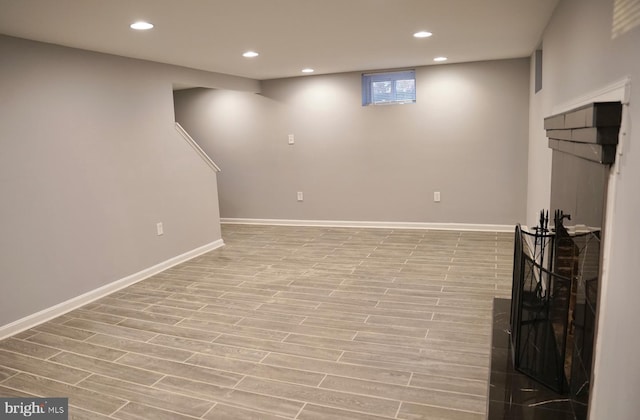 basement with light hardwood / wood-style flooring