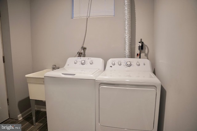 clothes washing area featuring dark wood-type flooring and washer and dryer