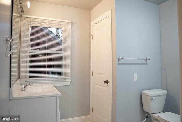 bathroom featuring toilet and vanity