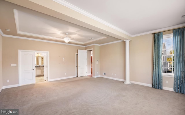 unfurnished bedroom with ensuite bath, ceiling fan, decorative columns, light carpet, and a raised ceiling