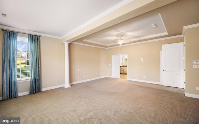 spare room featuring ornamental molding, a raised ceiling, light carpet, and ornate columns