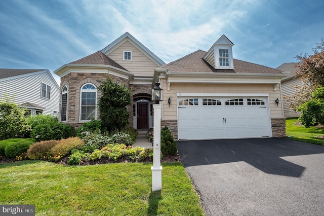 view of front of property featuring a garage and a front lawn