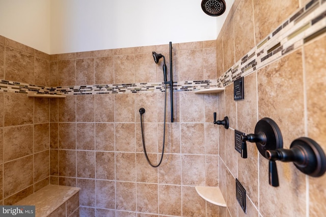 bathroom with a tile shower