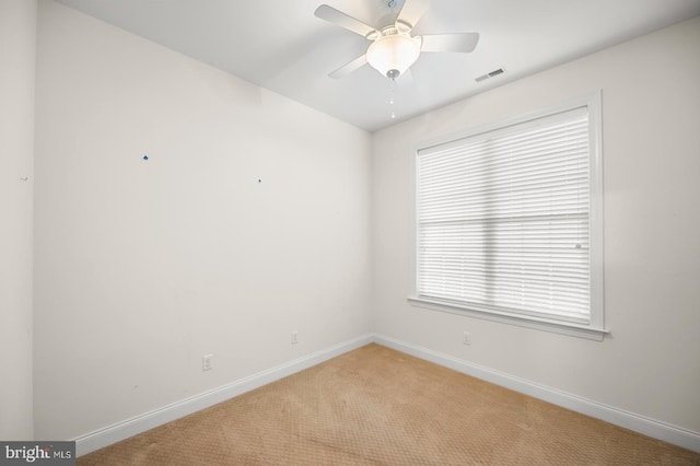 unfurnished room with ceiling fan and light colored carpet