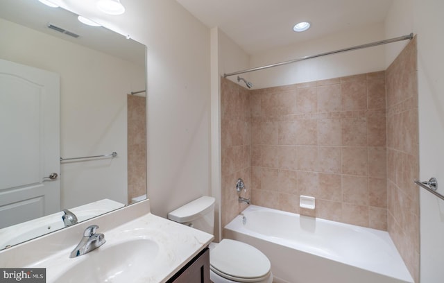 full bathroom with vanity, toilet, and tiled shower / bath