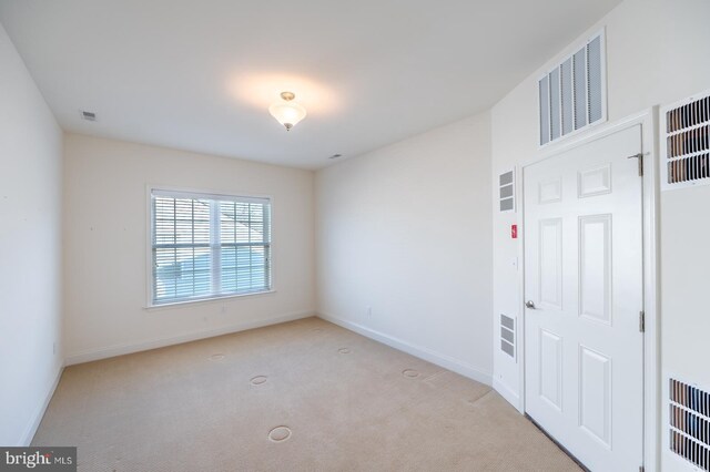 unfurnished room with light carpet