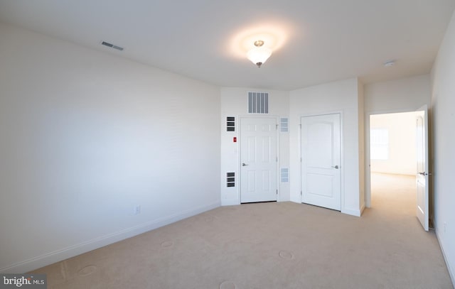 unfurnished bedroom featuring light colored carpet