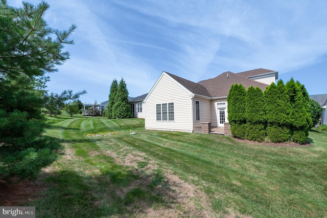 view of home's exterior with a yard