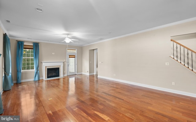 unfurnished living room featuring crown molding, ceiling fan, and light hardwood / wood-style floors