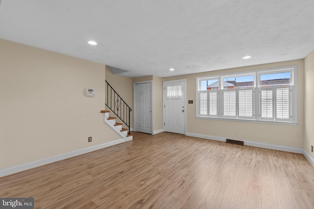 foyer entrance with light hardwood / wood-style floors