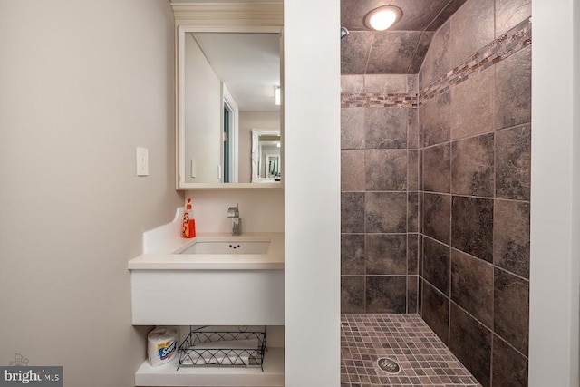 bathroom with sink and a tile shower