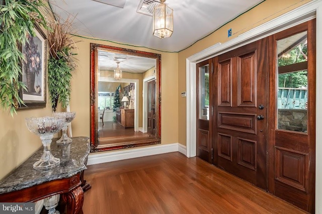 foyer entrance featuring dark wood-type flooring