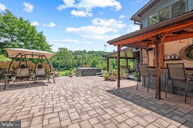 view of patio / terrace with a hot tub