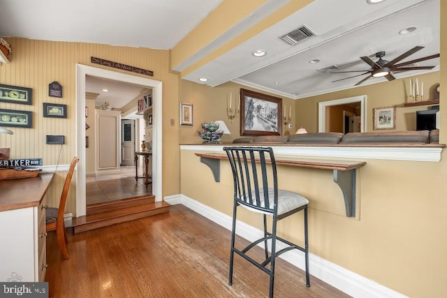 kitchen with lofted ceiling, tile patterned floors, a breakfast bar, and ceiling fan