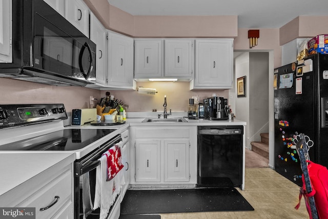 kitchen featuring black appliances, white cabinetry, and sink