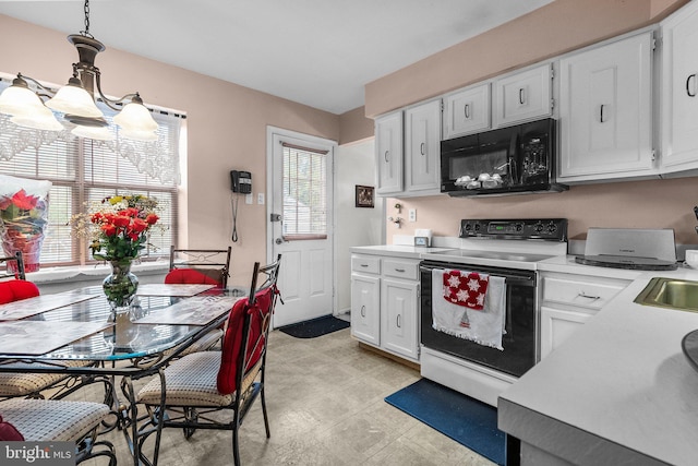 kitchen with white cabinets, pendant lighting, white electric stove, and sink