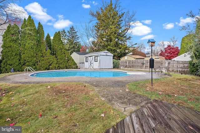 view of swimming pool with a yard and a storage unit