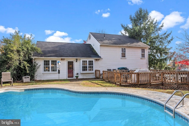 view of swimming pool featuring a wooden deck