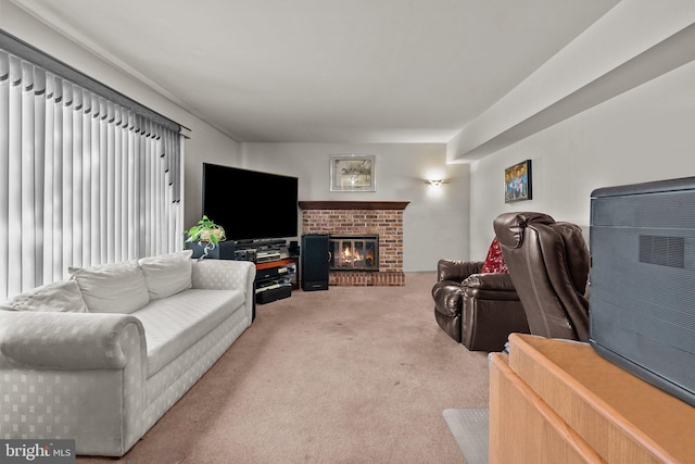 carpeted living room with a brick fireplace