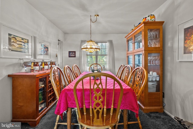 carpeted dining space featuring a notable chandelier