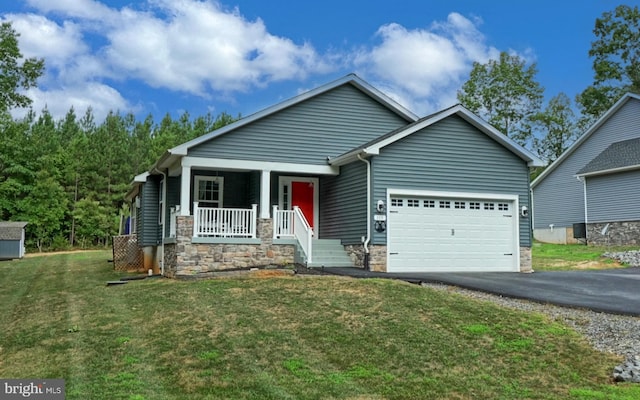 craftsman-style home with a garage, covered porch, and a front yard