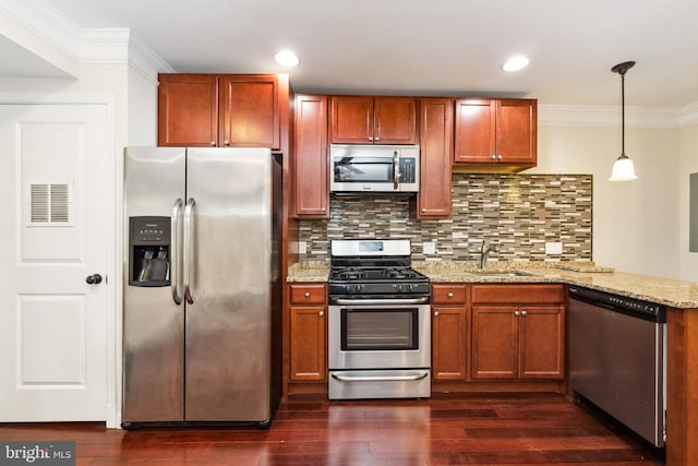 kitchen featuring decorative light fixtures, sink, decorative backsplash, light stone counters, and stainless steel appliances