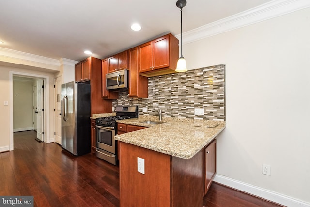 kitchen featuring sink, stainless steel appliances, light stone counters, decorative light fixtures, and kitchen peninsula