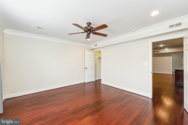 empty room featuring ceiling fan, ornamental molding, and dark hardwood / wood-style floors