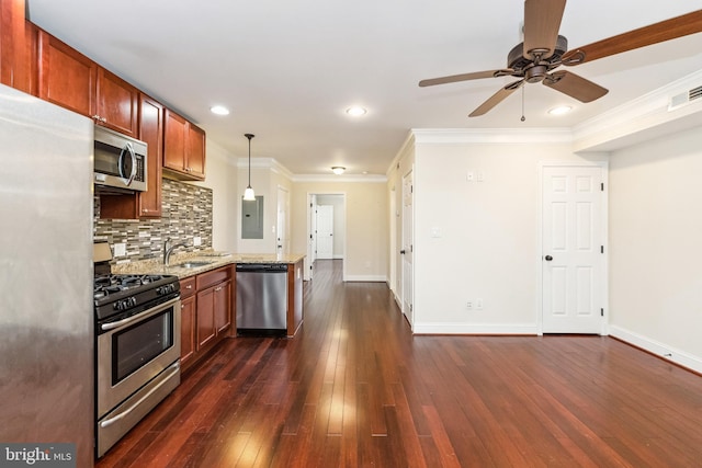 kitchen featuring sink, backsplash, stainless steel appliances, light stone countertops, and decorative light fixtures