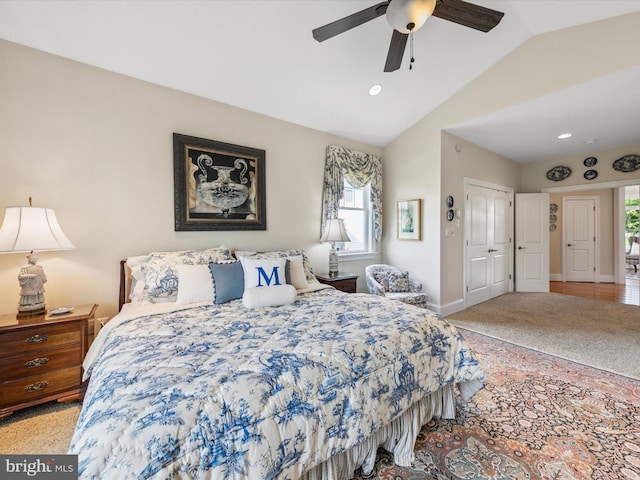 bedroom featuring light carpet, ceiling fan, vaulted ceiling, and a closet