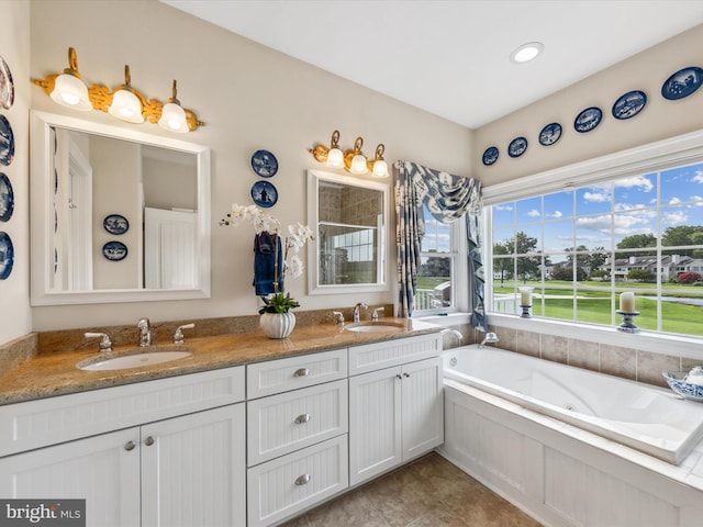 bathroom with vanity and separate shower and tub