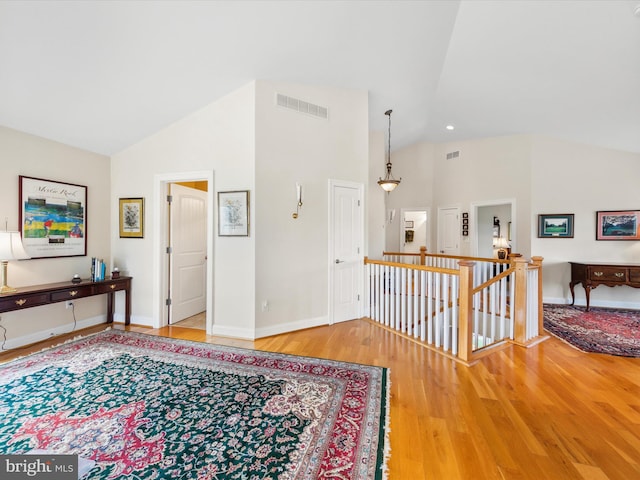 interior space featuring high vaulted ceiling and light wood-type flooring