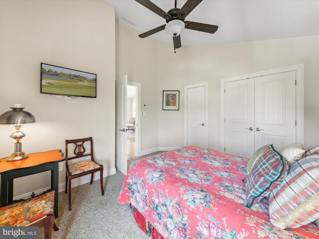 carpeted bedroom with vaulted ceiling, ceiling fan, and a closet